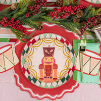 Place setting with nutcracker plate and icy blue guest towel with gold edge.
