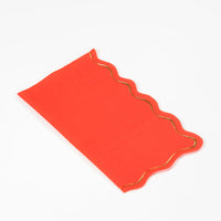 Classic red guest towel with gold scalloped border, angled view.