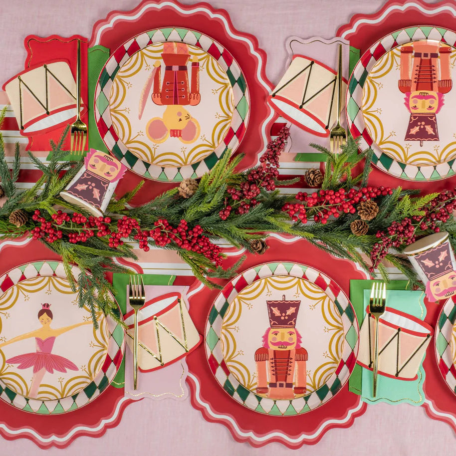 Overhead table with nutcracker plates and mixed color guest towels at each setting.