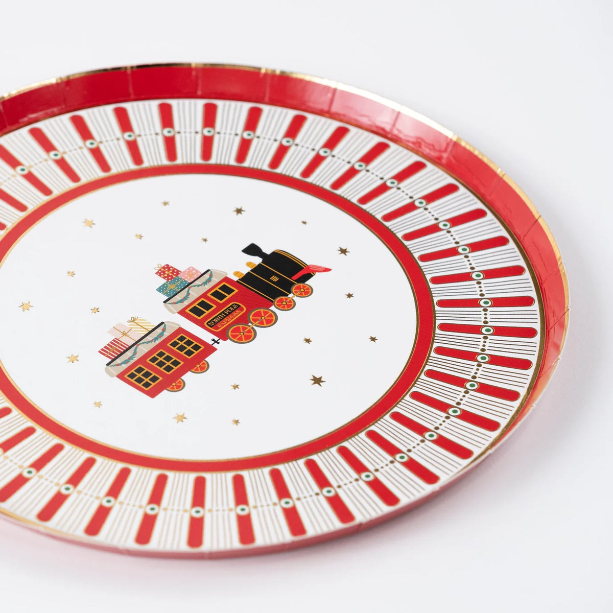 Dessert plate with vintage christmas train in the center and star accents.