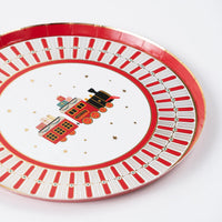 Dessert plate with vintage christmas train in the center and star accents.