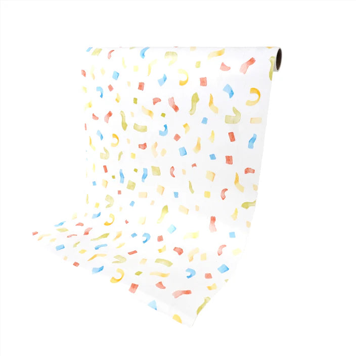 Paper table runner roll draped down to show the confetti print and length.
