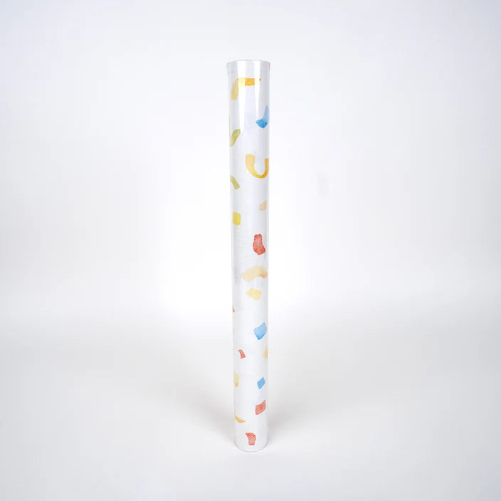 Upright roll of paper table runner printed with watercolor confetti on white.