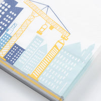 Closeup of folded construction napkin with yellow crane and blue skyline.