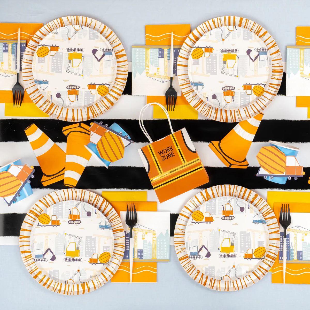 Overhead table set for a construction party with plates, cones, and crane napkins.