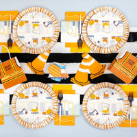 Overhead spread of multiple construction plates with cones and work zone bags.