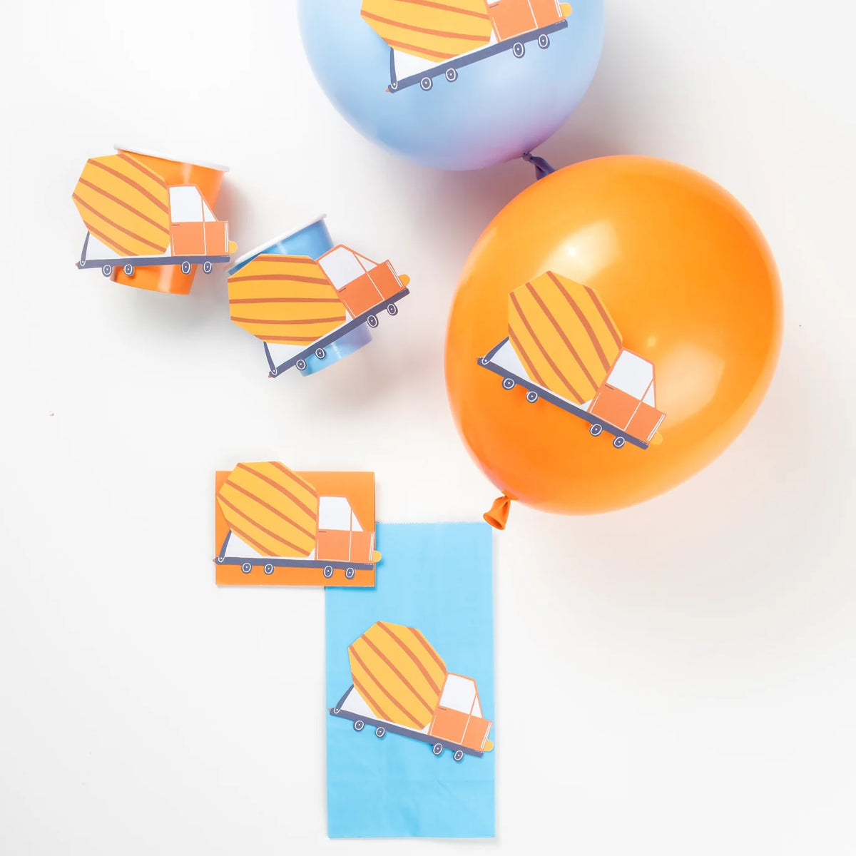 Orange and blue balloons and cups decorated with cement truck accent stickers.