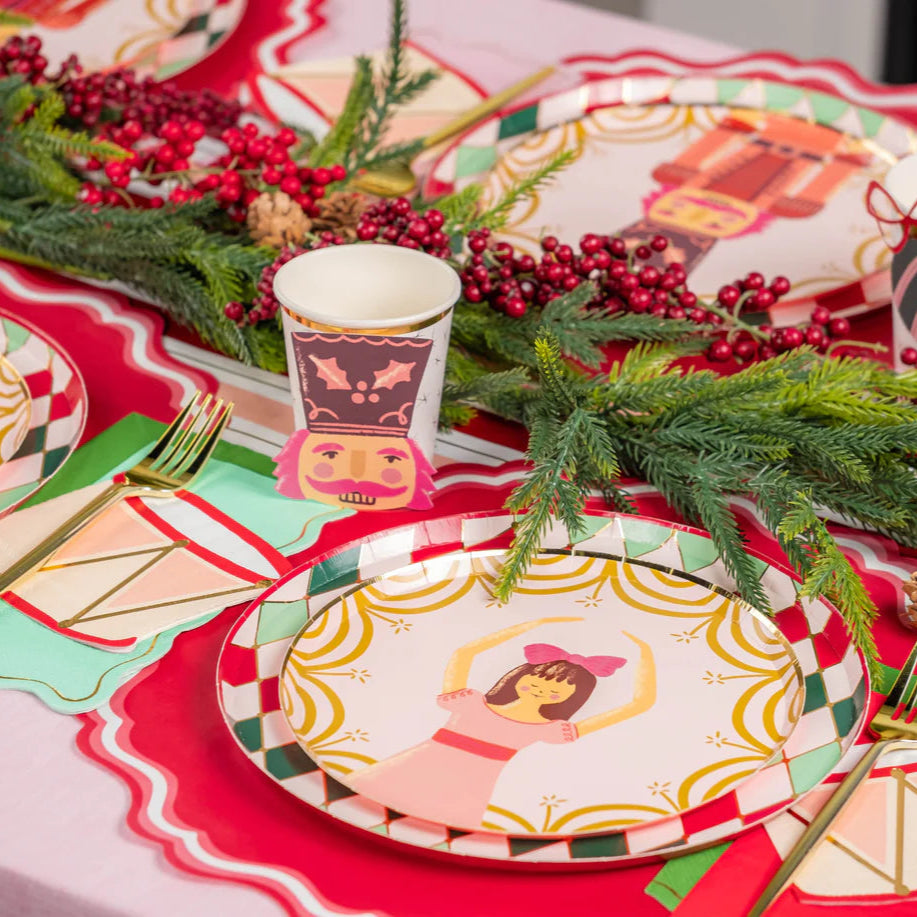 Table view showing ballerina plate, diamond rim, drum napkins, and evergreen garland.
