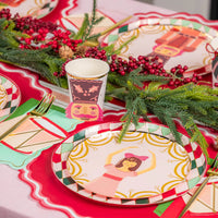 Table view showing ballerina plate, diamond rim, drum napkins, and evergreen garland.