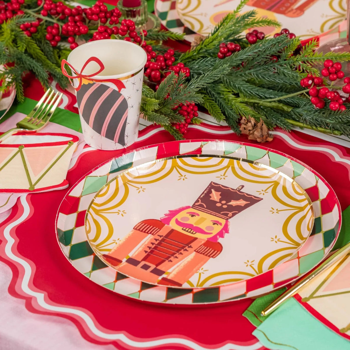 Close place setting with diamond rim plate beside a pink candle and ornament cup.