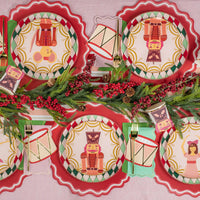 Decorative Christmas plates with Nutcracker design on a pink background