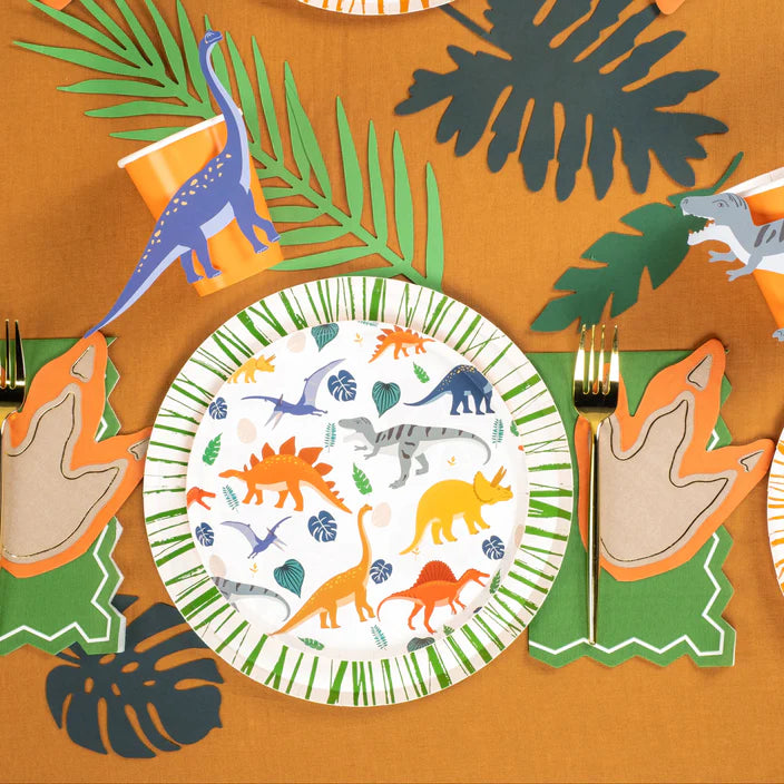 Overhead place setting with green rim dinosaur plate and leaf decor.