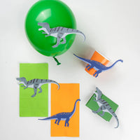 Green balloon, cups, and treat bags decorated with T-Rex and long neck stickers.