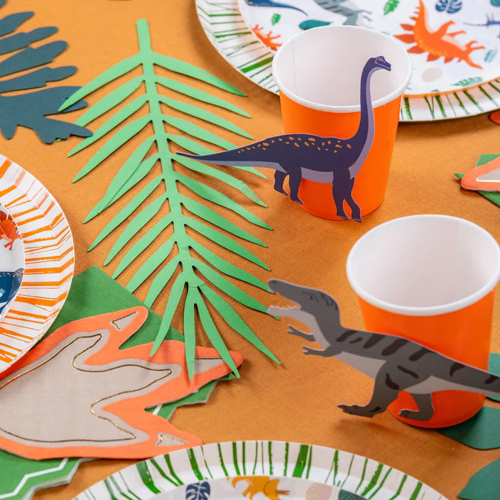 Dino party table with cups and plates styled with blue long neck and gray T-Rex stickers.