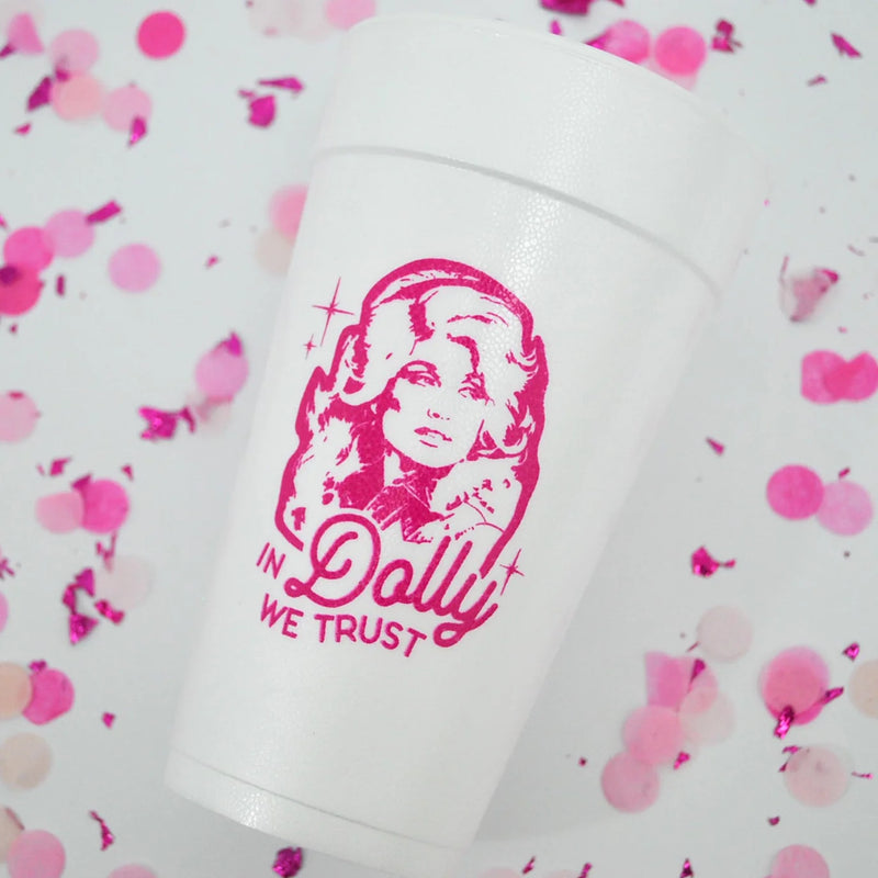 White 20 oz foam cup with hot pink “In Dolly we trust” graphic surrounded by pink confetti.