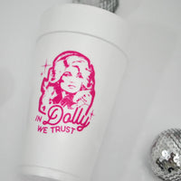 Foam cup with Dolly graphic next to silver disco ball on white background.