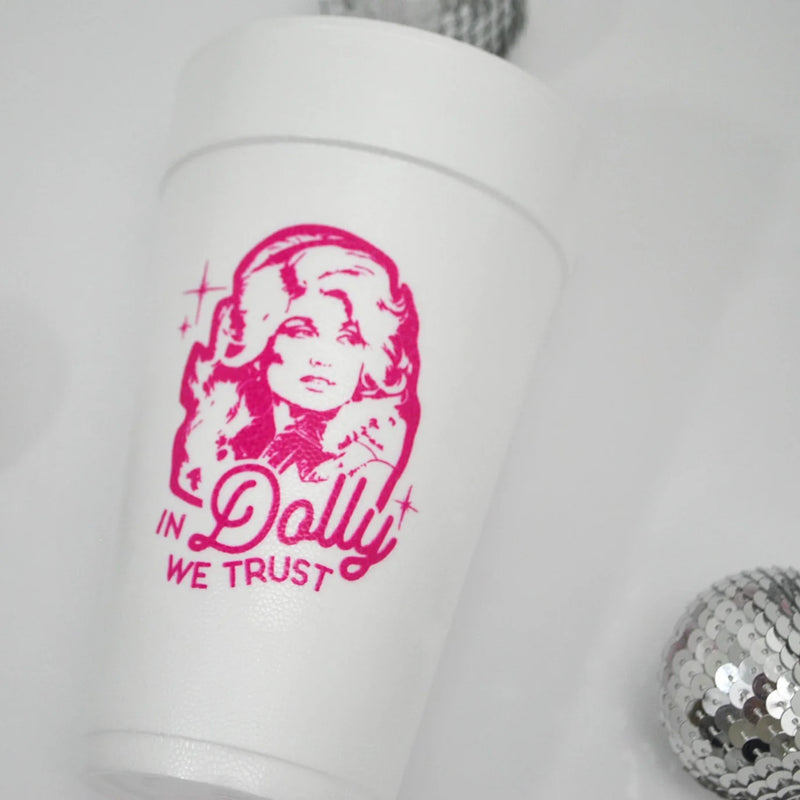 Foam cup with Dolly graphic next to silver disco ball on white background.