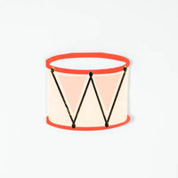Isolated die cut drum napkin on white background, front view.