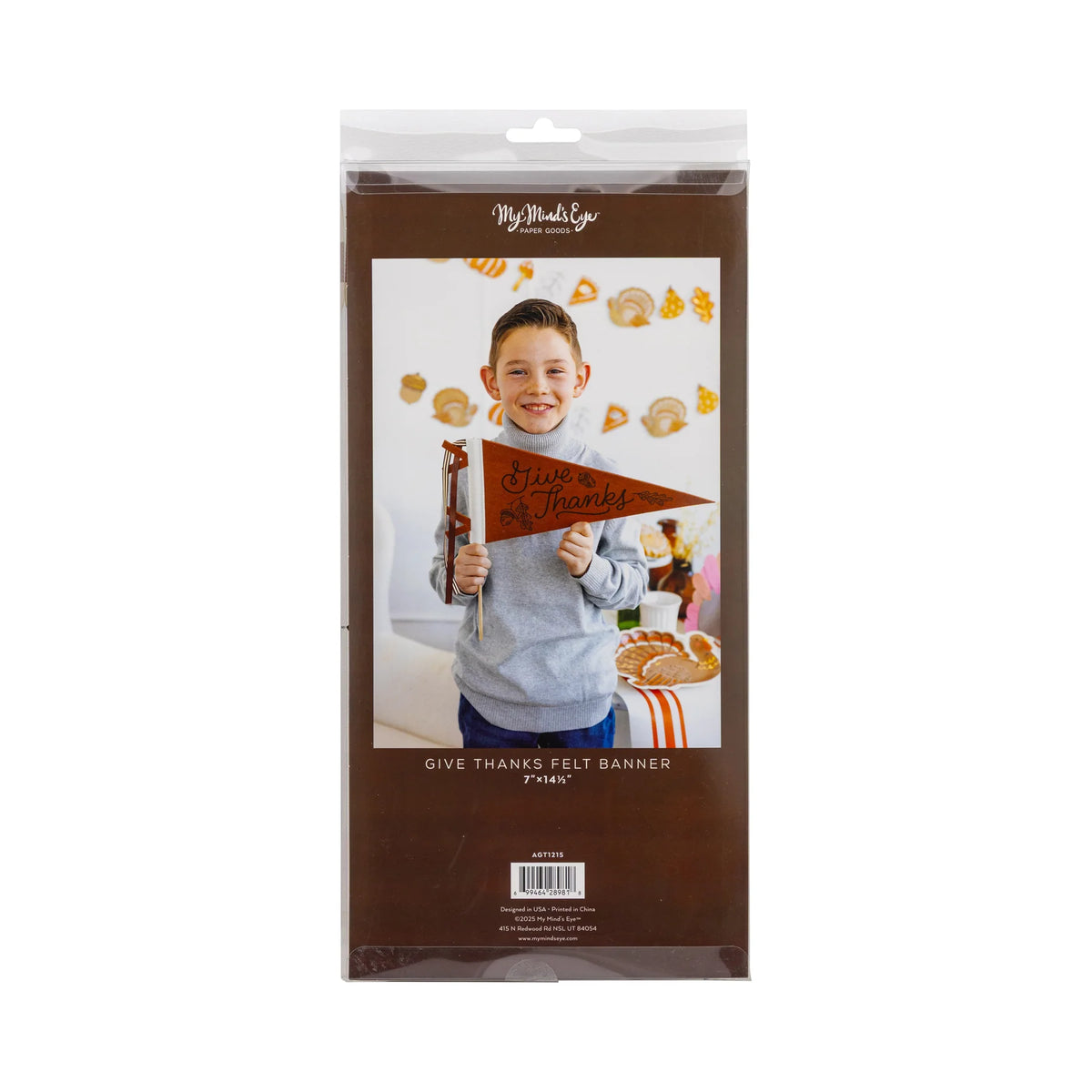 Retail package showing a boy holding a brown felt Give Thanks pennant, with fall decor in the background.