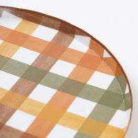Closeup of harvest plaid rim showing sage green, pumpkin orange, mustard yellow checks.