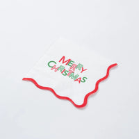 Single Merry Christmas cocktail napkin with wavy red border on white background.