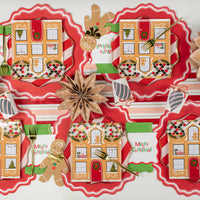 Gingerbread house plate tablescape with Merry Christmas napkins at each setting.