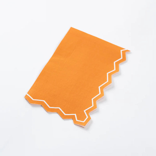 Folded orange guest towel showing zigzag border.