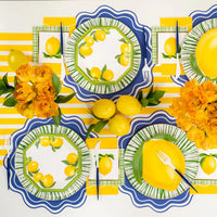 Lemon themed tablescape using green Radiance rim plates with blue placemats.