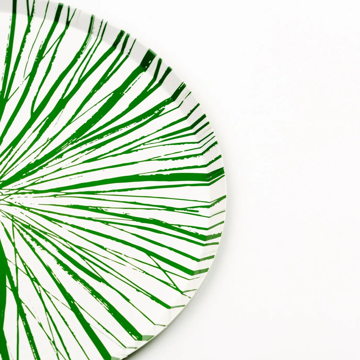 Edge view of green Radiance dinner plate showing burst lines and rim.