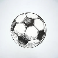 Single round soccer ball paper placemat photographed overhead on white.