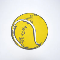 Single round yellow tennis ball paper placemat photographed overhead on white.