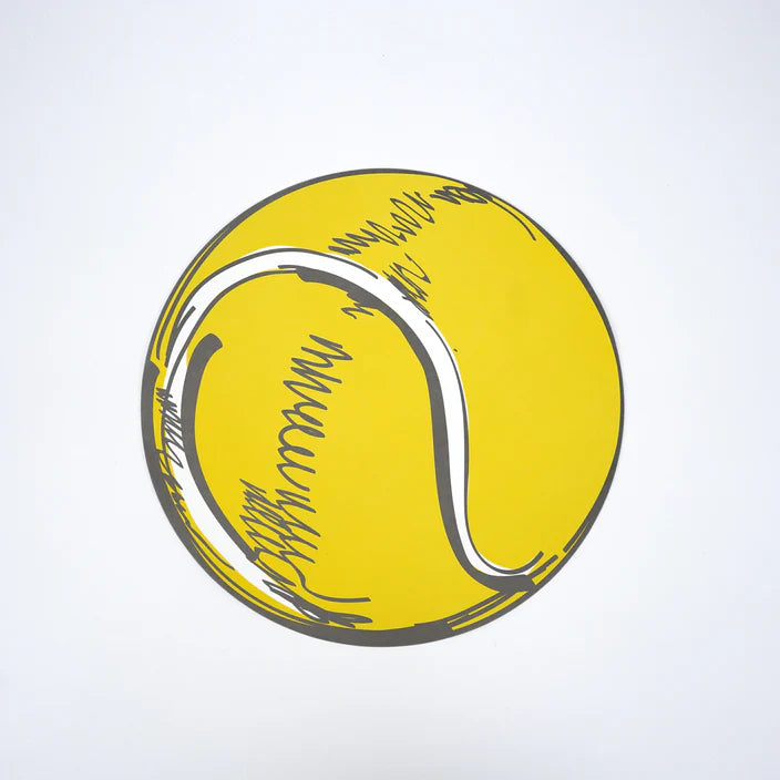Single round yellow tennis ball paper placemat photographed overhead on white.