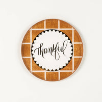 Brown grid dessert plate with “thankful” center on white background.