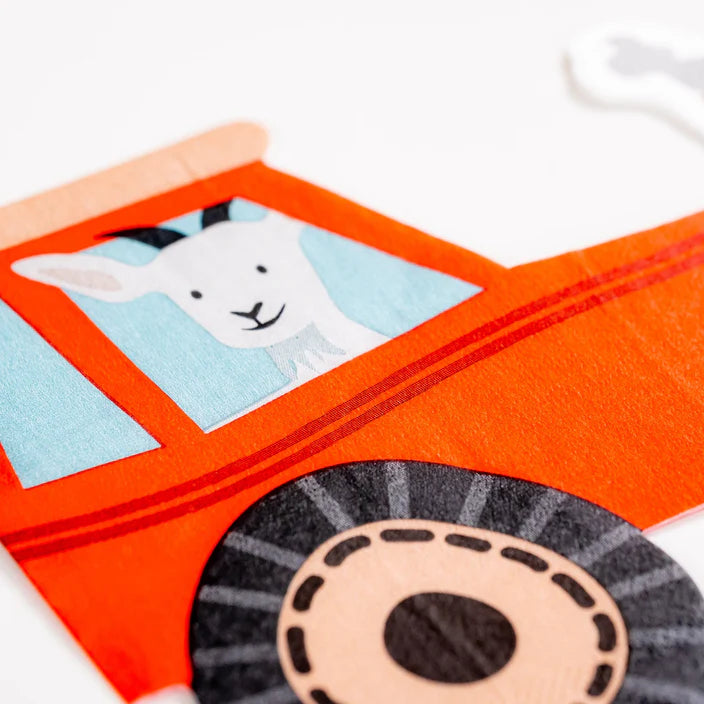 Closeup of tractor napkin window showing smiling goat illustration.