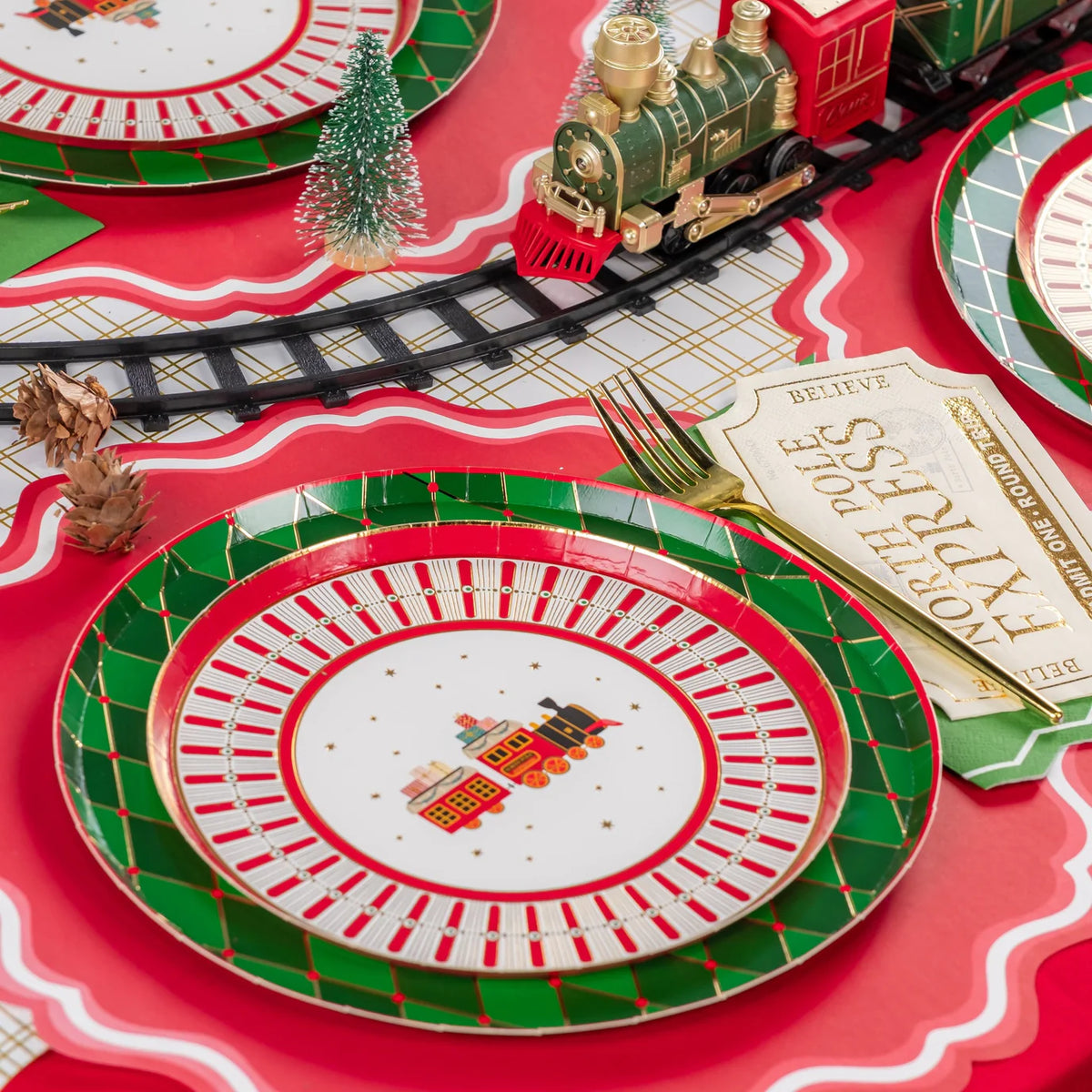 Angle place setting showing train plate with ticket card and gold fork near the tracks.