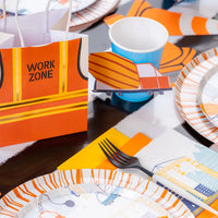 Favor bag and blue cup at a work zone table, both styled with a cement truck sticker.