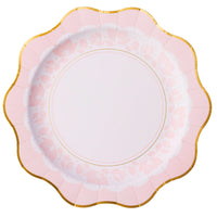 Close‑up of blush pink dinner plate showing delicate floral border and gold scalloped rim.