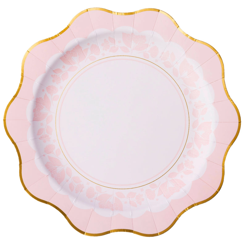 Close‑up of blush pink dinner plate showing delicate floral border and gold scalloped rim.