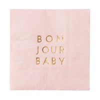 Close‑up angle of a folded Bonjour Baby napkin showing soft 3‑ply texture and metallic gold text.