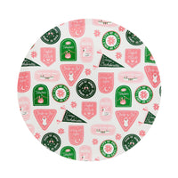 Close-up of round Camp Bachelorette dinner plate featuring pink and green badge illustrations