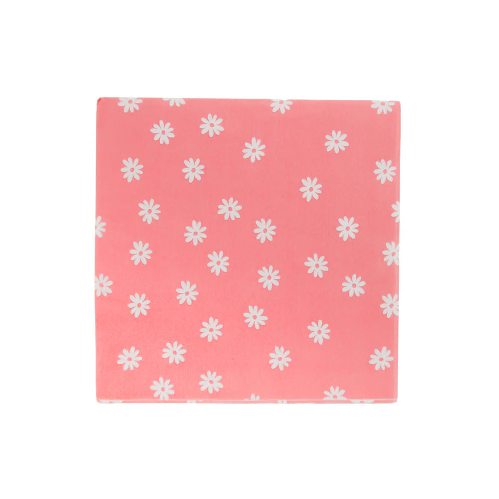 Close-up of folded pink napkin sprinkled with small white daisy icons