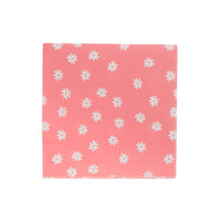 Close-up of folded pink napkin sprinkled with small white daisy icons