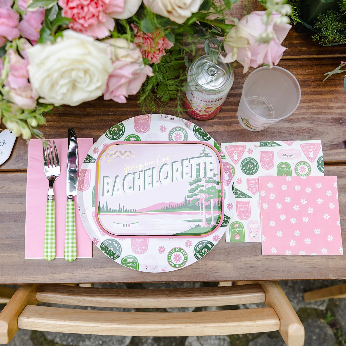 Flat-lay photo of Camp Bachelorette large napkin showing pink and green camp-patch design
