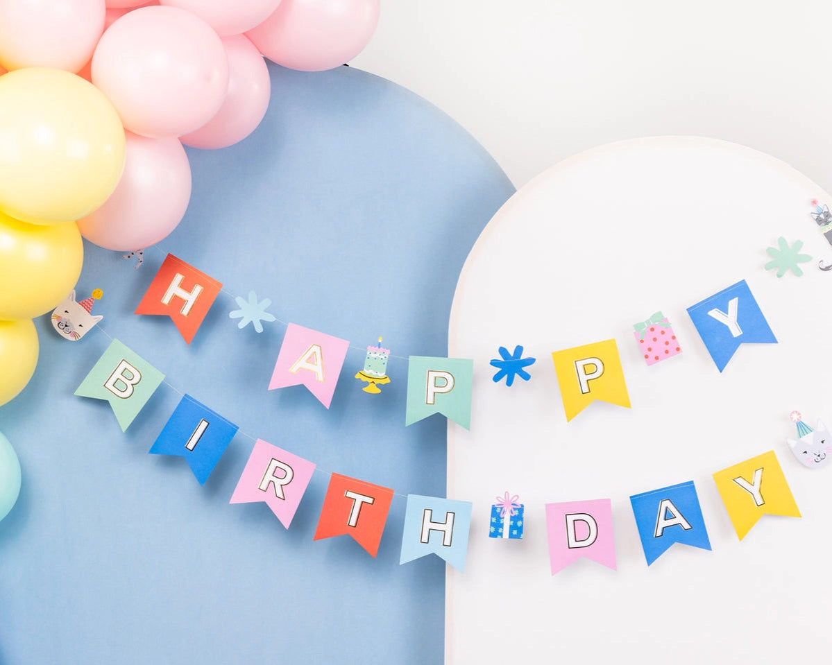 Close-up of assembled pastel Cat Happy Birthday Banner with gift and cake cut-outs

