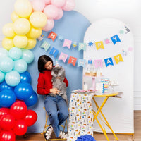 Woman seated with gray cat wearing party hat, Cat Happy Birthday Banner in background