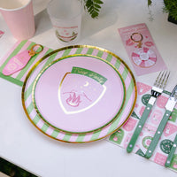 Table setting showing large and small pink-green stripe plates layered with camp badge plate, napkin, and flatware