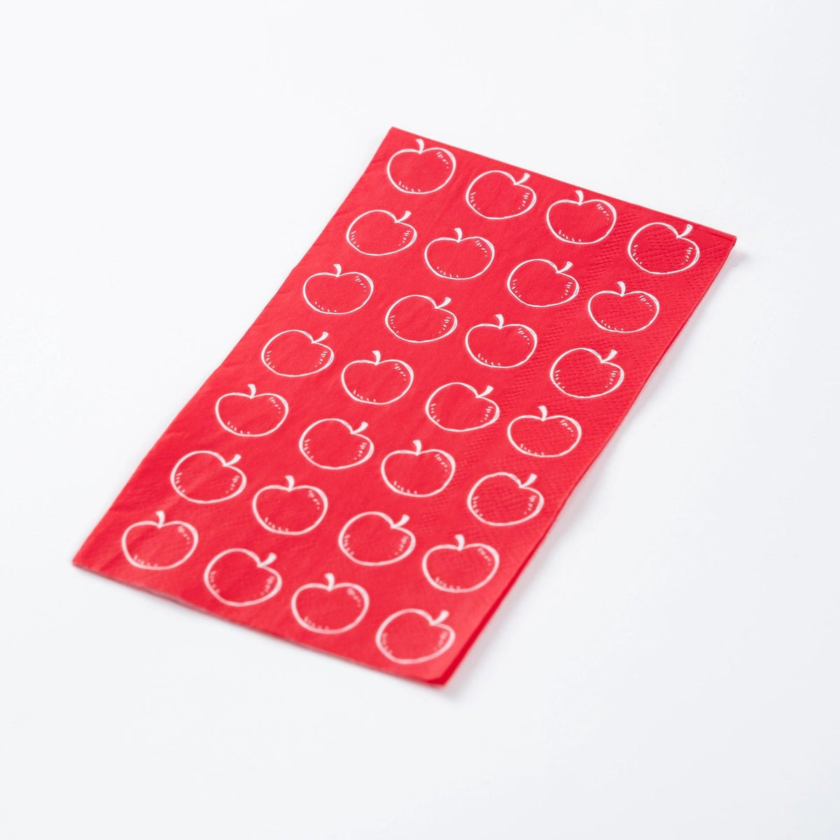 Close-up of crisp white apple outlines on vibrant red three-ply paper towel.