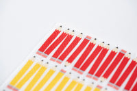 Macro view of red pencil stripe pattern on three-ply paper napkin.