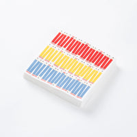 Stack of white beverage napkins printed with red, yellow, and blue pencil stripes.