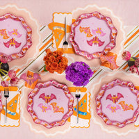 Overhead Halloween tablescape featuring Bats and Bows plates and cups with matching bat stickers.